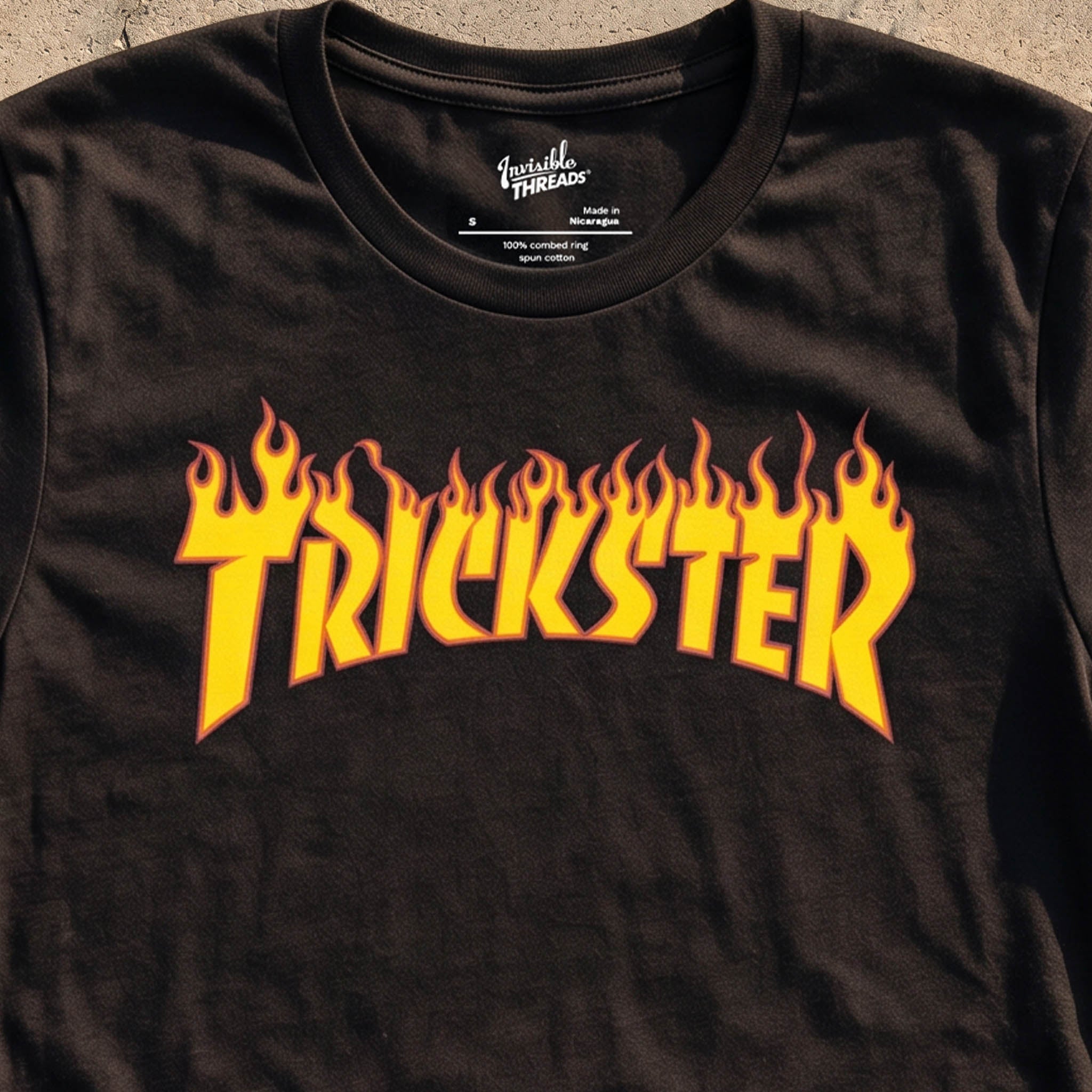 Black Trickster t-shirt featuring skate-inspired flaming yellow orange and red logo lettering